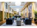 Bright and spacious lobby featuring contemporary furniture, large windows, and stylish decor and plants at 127 N Tryon St # 301, Charlotte, NC 28202