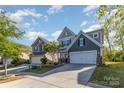 Beautiful two-story home with well manicured lawn and long driveway leading to the two car garage at 1313 Loggerhead Dr, Lancaster, SC 29720