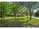 Traditional home featuring a well-manicured lawn, shade trees, and a quaint covered porch at 1325 Red Oaks Dr, Rock Hill, SC 29730