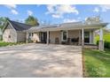 Welcoming covered porch with stone accents, ceiling fan, and room for relaxing at 14855 Nc 801 Hwy Hwy, Mt Ulla, NC 28125