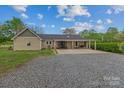 Charming single story home featuring a welcoming front porch with stone details at 14855 Nc 801 Hwy Hwy, Mt Ulla, NC 28125