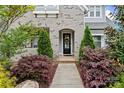 Charming entrance with an arched doorway and a walkway flanked by landscaped bushes at 1501 Riverwalk Pkwy, Rock Hill, SC 29730