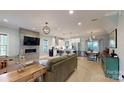 Open-concept living room with fireplace, seamlessly connected to the modern kitchen and dining area at 1511 Landis Ave, Charlotte, NC 28205