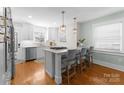 Modern kitchen island with stainless steel appliances, pendant lighting, and bar seating, stylish and functional at 1751 Merriman Ave, Charlotte, NC 28203