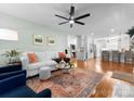 Bright living room connected to a modern kitchen, featuring hardwood floors and stylish furnishings at 1751 Merriman Ave, Charlotte, NC 28203