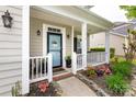 Inviting front porch with white railings, a decorative wreath, and thoughtfully designed landscaping at 2012 Galty Ln, Charlotte, NC 28270