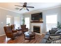 Comfortable living room with a fireplace, hardwood floors, and plenty of natural light at 2012 Galty Ln, Charlotte, NC 28270
