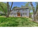 Classic home exterior with a covered porch, wooden trim and a beautifully manicured front lawn at 218 Kimrod Ln, Charlotte, NC 28270