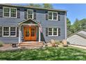 Inviting home exterior featuring a wood door, and charming seating on a well-kept lawn at 218 Kimrod Ln, Charlotte, NC 28270