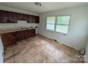 Functional kitchen featuring ample counter space, storage cabinets, and a window for natural light at 2308 English Dr, Charlotte, NC 28216