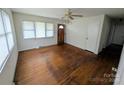 Bright living room featuring hardwood floors, neutral walls, and a ceiling fan with a light fixture at 2308 English Dr, Charlotte, NC 28216