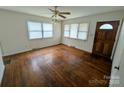 Bright living room with beautiful hardwood floors, ample natural light and a classic ceiling fan at 2308 English Dr, Charlotte, NC 28216