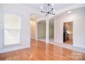 Living room features hardwood floors, arched entryways and natural light at 2415 Tory Oak Pl, Matthews, NC 28105
