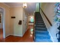Bright foyer with hardwood floors, stairs, and a glimpse into the kitchen at 2540 Heritage Cir, Statesville, NC 28625