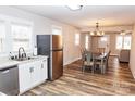 Modern kitchen with stainless steel appliances, granite countertops, and an adjacent dining area at 2693 Salem Church Rd, Lincolnton, NC 28092