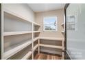 Well-organized pantry with ample shelving and a window for natural light at 28647 Nc Hwy 73 Hwy, Albemarle, NC 28001