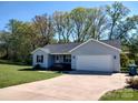 Charming single-story home with a well-maintained lawn and attached two-car garage at 295 Green Meadows Dr, Taylorsville, NC 28681