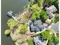 Breathtaking aerial view of home nestled on tree-lined peninsula with private dock at 302 Patterson'S Bridge None, New London, NC 28127