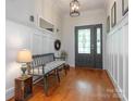 Welcoming foyer with hardwood floors, paneled walls, and a decorative front door with stained glass at 3033 Beech Ct, Indian Trail, NC 28079