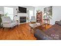 Spacious living room featuring a cozy fireplace, hardwood floors, and neutral decor at 3033 Beech Ct, Indian Trail, NC 28079