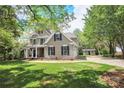 Inviting two-story home boasts a lush lawn, attached garage, and beautiful landscaping at 312 Peach St, Shelby, NC 28150