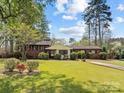 Charming brick home with a well-manicured lawn and mature landscaping at 365 Pine Hill Rd, Salisbury, NC 28144