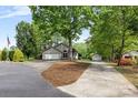 A charming, single-story stucco home with a stone-accented entrance, two-car garage, and a well-kept lawn at 3764 Glenn Oaks Dr, Maiden, NC 28650