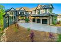 Beautiful exterior view of home featuring a three-car garage, manicured landscaping, and a stone and brick facade at 385 Squirrel Ln, Clover, SC 29710
