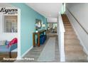 Bright entryway featuring wood-look flooring, stairs to the right, and a modern console table at 3920 Coleman Dr, Charlotte, NC 28215