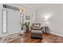 Warm and welcoming foyer with hardwood floors, chair, and natural light at 4012 Brandywine Ter, Lancaster, SC 29720