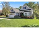 Charming home featuring a stone facade, manicured lawn, and a two-car garage at 4012 Brandywine Ter, Lancaster, SC 29720