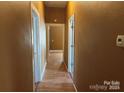 Hallway with wood-look floors offers sightlines to various rooms within the home at 421 E Cemetary St, Salisbury, NC 28144