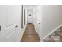 Bright hallway with light wood floors and white doors, leading to a welcoming entrance at 5232 Reedy Ridge Rd, Charlotte, NC 28215