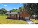 Charming brick two-story home with well-manicured lawn and attached garage at 5301 Baker Dr, Charlotte, NC 28210