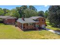 Inviting brick home with covered porch and a well-maintained front lawn at 5301 Baker Dr, Charlotte, NC 28210