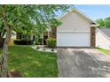 Lovely home featuring a manicured lawn, a brick-accented facade, and a convenient two-car garage at 5927 Patricia Ryan Dr, Charlotte, NC 28216