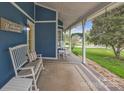 Inviting front porch with rocking chairs and a welcome bench, perfect for relaxing outdoors at 63 Frost Ln, Taylorsville, NC 28681