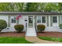 Inviting front entrance featuring a well-maintained brick facade and a meticulously landscaped walkway at 6339 Montpelier Rd, Charlotte, NC 28210