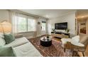 Bright living room featuring a plush sofa, a stylish rug, and large windows for natural light at 6339 Montpelier Rd, Charlotte, NC 28210