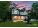 Beautiful two-story home with a well-manicured lawn, inviting porch, and professional landscaping at 6524 Robert St, Huntersville, NC 28078
