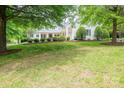 Well-manicured front yard with lush lawn and mature trees at 7701 Gold Hill Rd, Rockwell, NC 28138