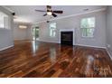 Bright living room with hardwood floors, a cozy fireplace, and sliding door to backyard at 8607 Cedardale Ridge Ct, Charlotte, NC 28269