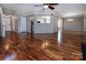 Spacious living room with hardwood floors, large windows, and an open layout at 8607 Cedardale Ridge Ct, Charlotte, NC 28269