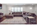 Inviting living room featuring a large sectional sofa and bright natural light at 901 Burnley Rd, Charlotte, NC 28210
