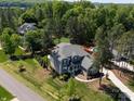 Stunning aerial view of the home, revealing its private backyard, mature trees, and inviting swimming pool at 101 Cross Current Ln # 137, Belmont, NC 28012