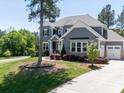 Well-maintained home showcasing mature trees, a manicured lawn, and a classic color scheme at 101 Cross Current Ln # 137, Belmont, NC 28012