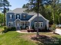 Beautiful two-story house with lush lawn and mature landscaping in a desirable neighborhood at 101 Cross Current Ln # 137, Belmont, NC 28012