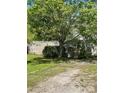 Tan single-story home featuring a small porch and mature trees at 104 Poplar St, Clover, SC 29710