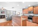 Open-concept kitchen with stainless steel appliances, granite countertops, and hardwood floors at 11447 Potters Row, Cornelius, NC 28031