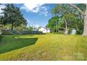 Expansive backyard with a lush green lawn and a wooden fence, providing ample space at 126 Hemphill Ave, Chester, SC 29706